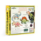 Back of the Dinosaur Dice Game by Eeboo box showing illustrations of the Brontosaurus, T-Rex, Triceratops, and Stegosaurus skeletons, along with game instructions, contents list, and a "Glow in the Dark" feature badge.