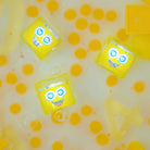 Yellow toy cubes with smiling faces on a yellow and white background