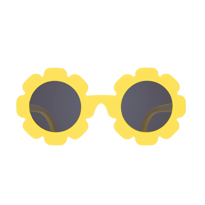 Yellow sunglasses with flower-shaped frames on a white background