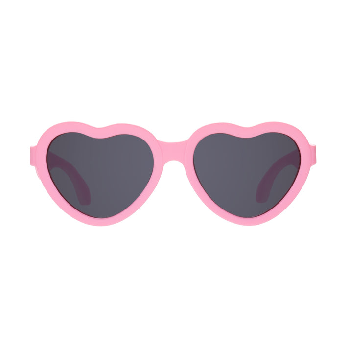 Heart-shaped sunglasses with pink frames on a white background