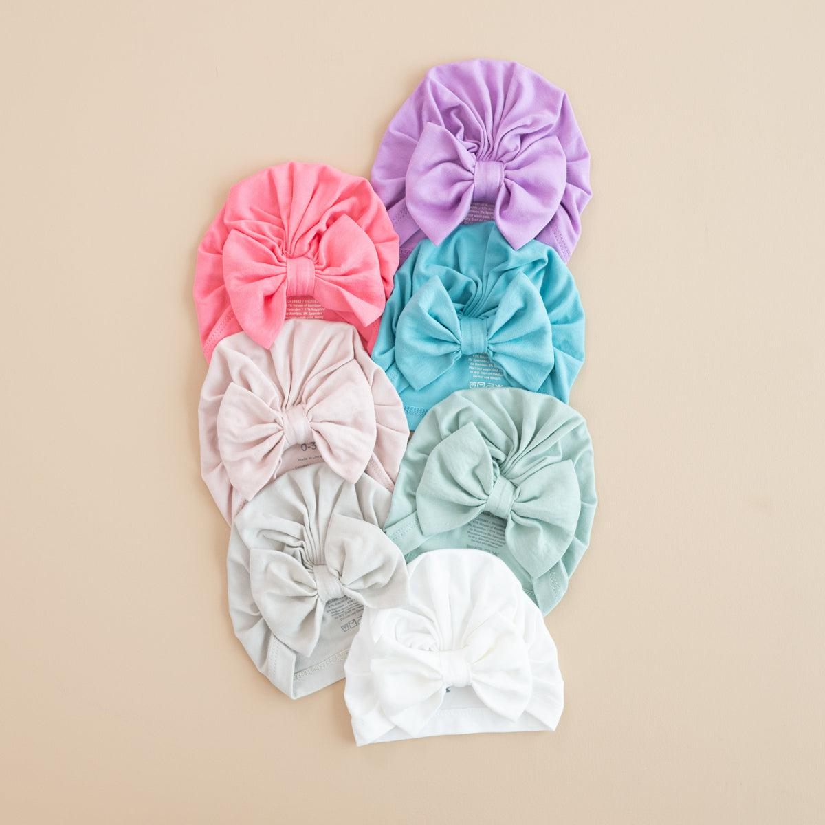 Set of colorful headbands with large bows on a beige background