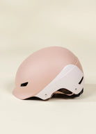 Pink helmet with white visor on a beige background