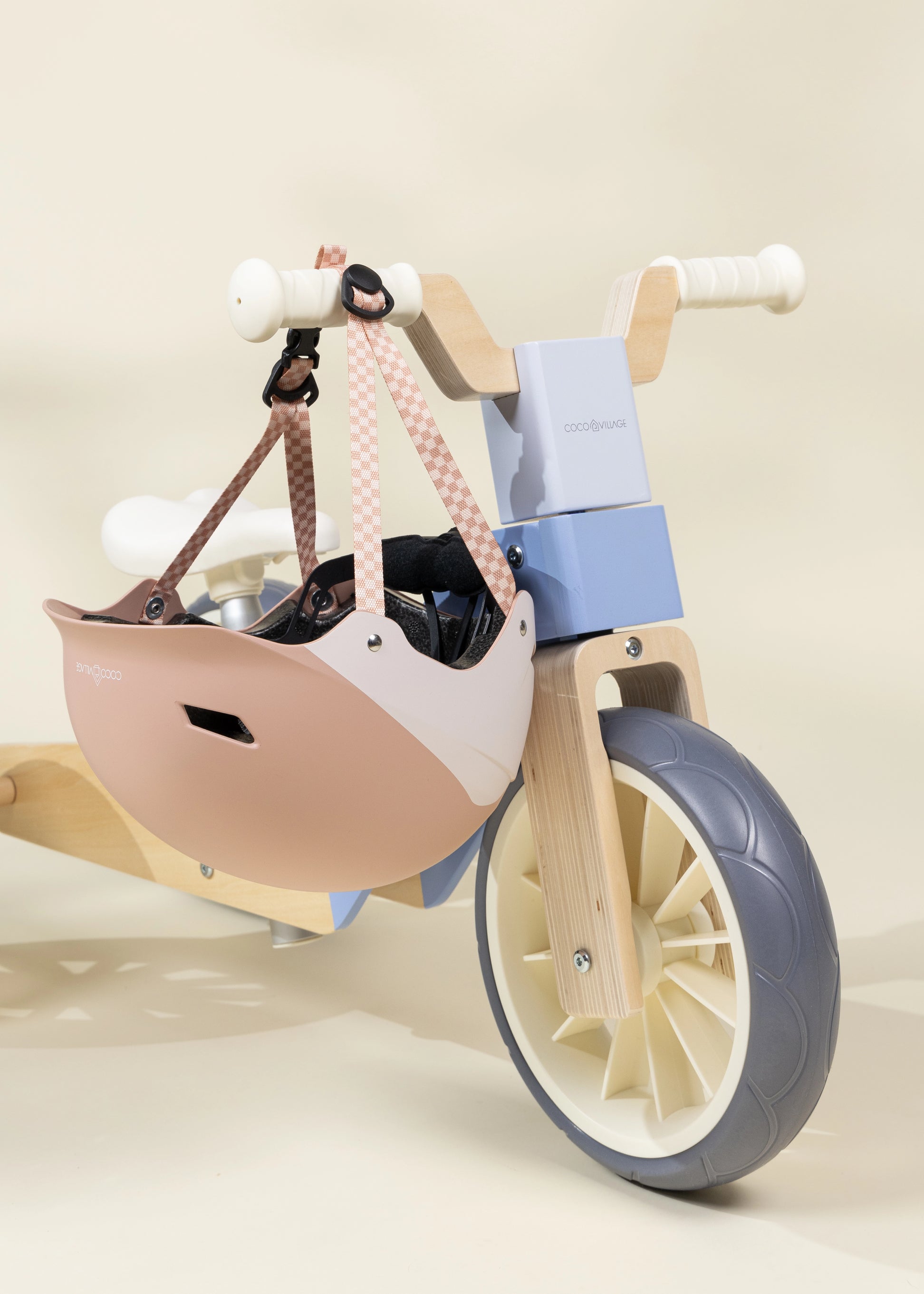 Children's balance bike with a basket on a plain background
