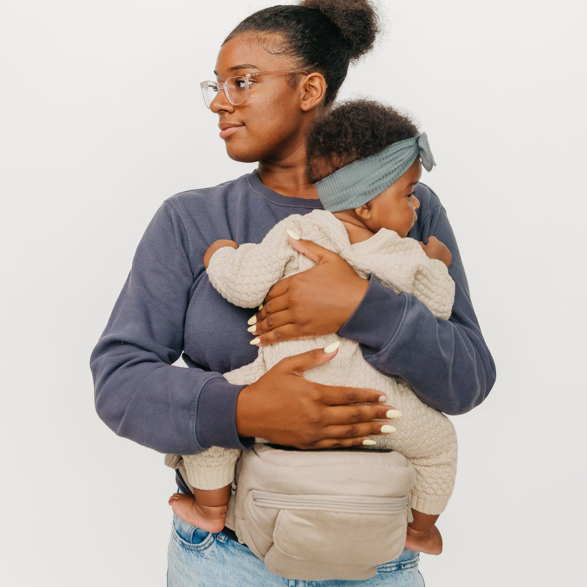 Woman holding a child against a white background