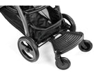 Close-up of a black stroller with a footrest on a white background