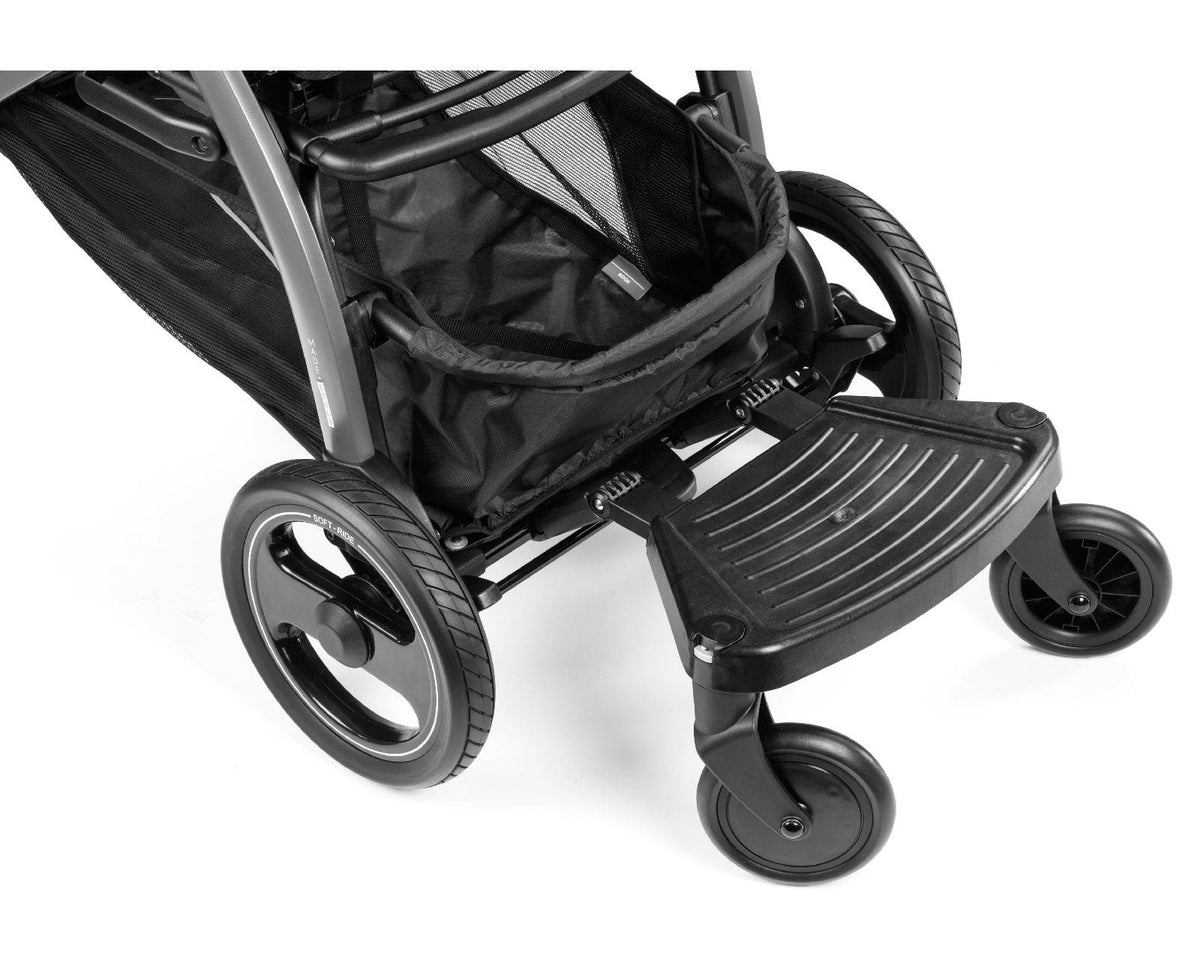 Close-up of a black stroller with a footrest on a white background