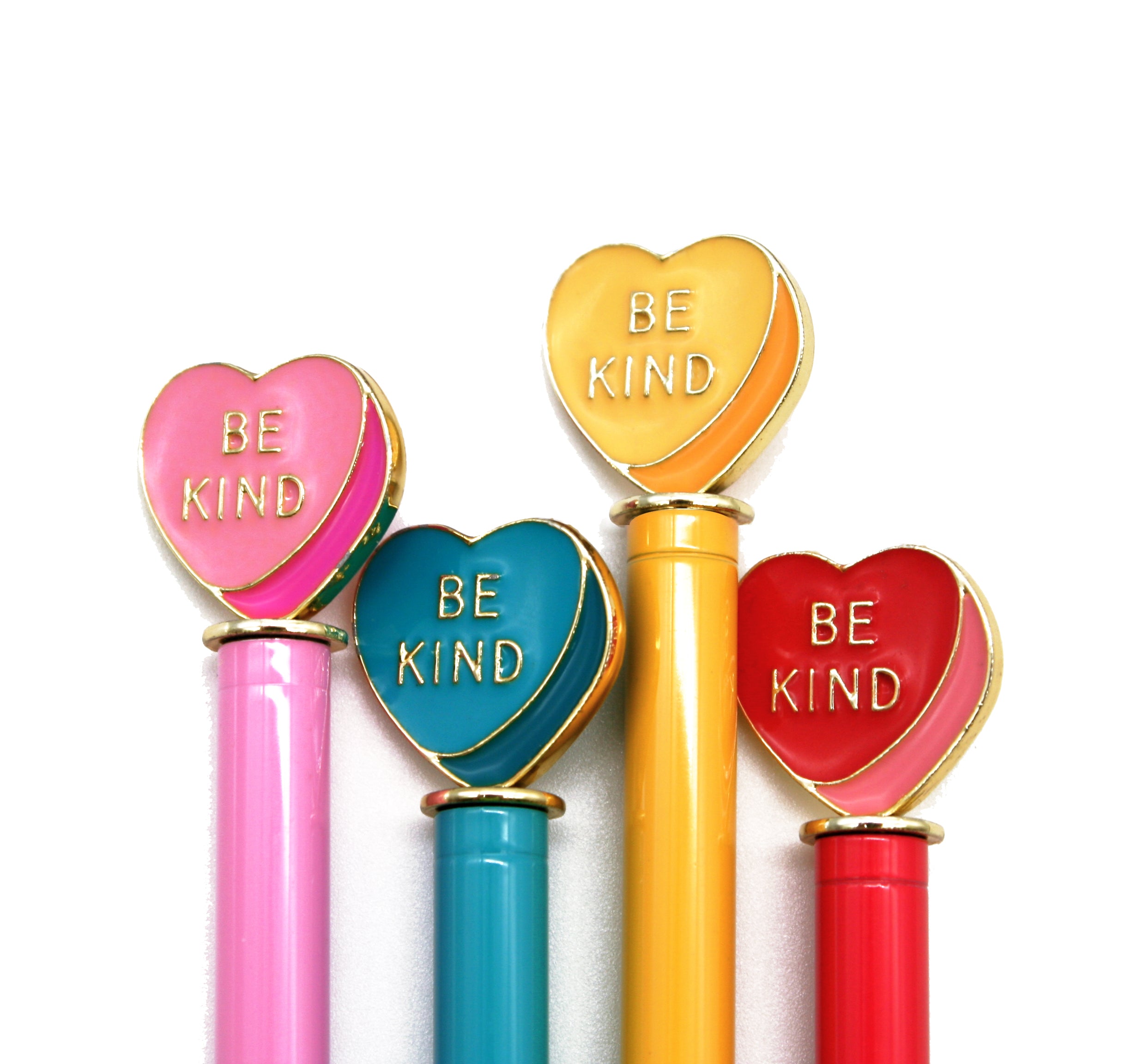 Four heart-shaped pens with 'BE KIND' text on a white background
