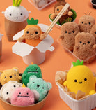 Various cute plush toys on an orange background