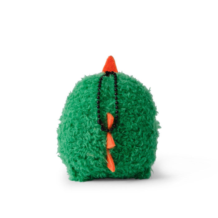 Green plush toy with orange accents on a white background