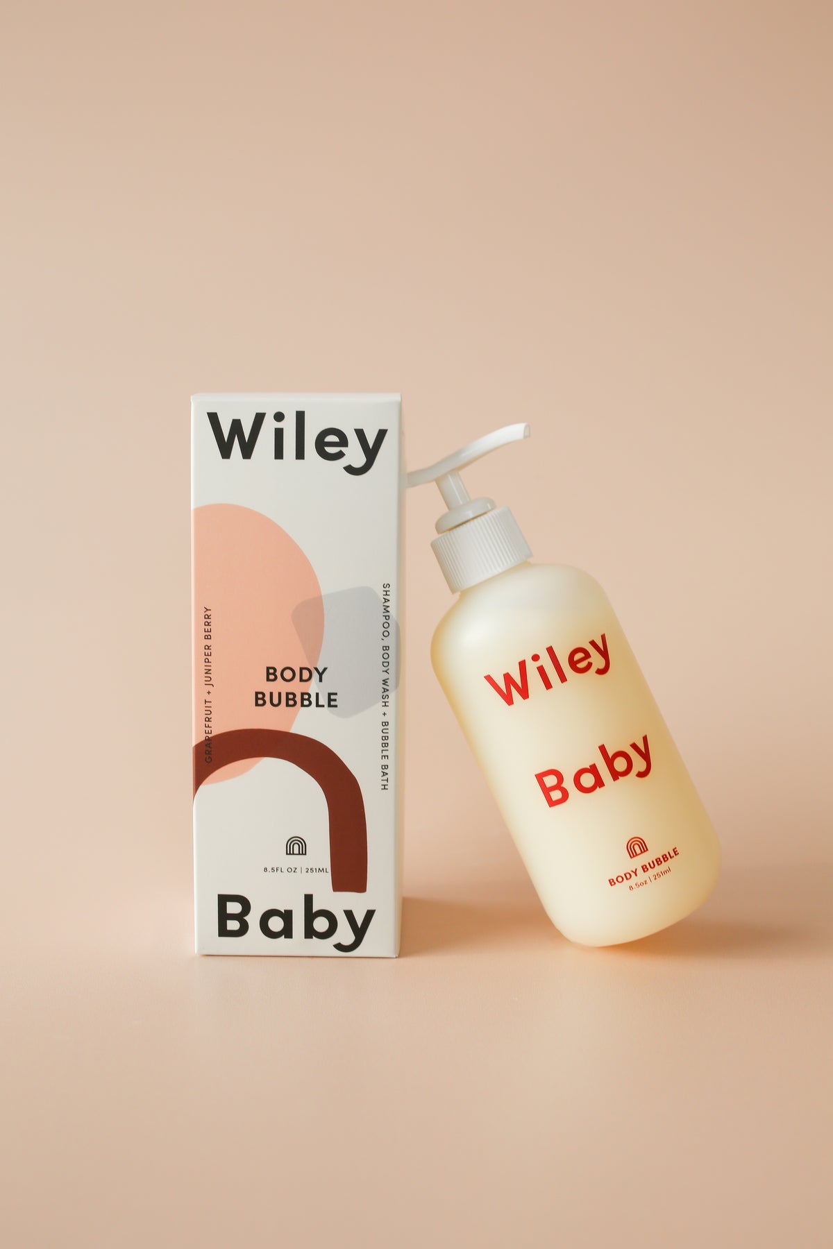 Wiley Baby body bubble bottle and packaging on a beige background