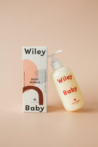 Wiley Baby body bubble bottle and packaging on a beige background