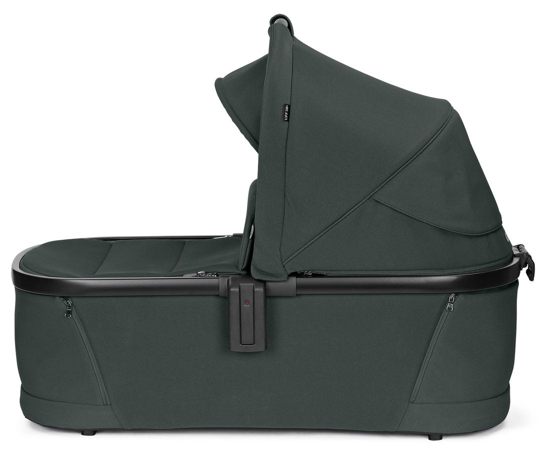 Dark green baby bassinet on a white background