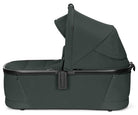 Dark green baby bassinet on a white background