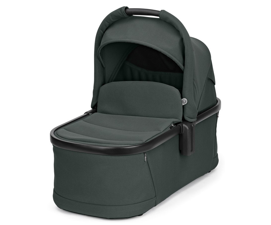 Dark green baby bassinet on a white background