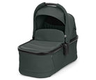 Dark green baby bassinet on a white background