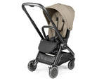 A Pippa Pro 4 stroller in a light beige/tan fabric with a black frame and wheels, shown from a three-quarters angle on a white background.