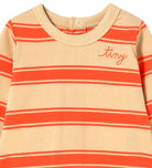 A close-up of a baby long-sleeve top with horizontal orange and white stripes on a beige background, featuring the word 'tiny' embroidered in orange script on the chest.