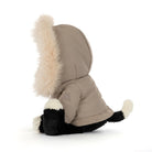A small plush dog toy wearing a beige hooded jacket with a fluffy cream faux-fur trim around the hood and black-and-white paws, photographed on a clean white background.