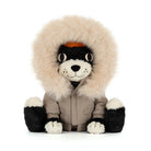 A plush dog toy wearing a beige parka jacket with a large cream fur hood, black and white face, and black-and-white paws, photographed on a clean white background.