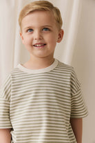 Young boy wearing a striped shirt against a plain background