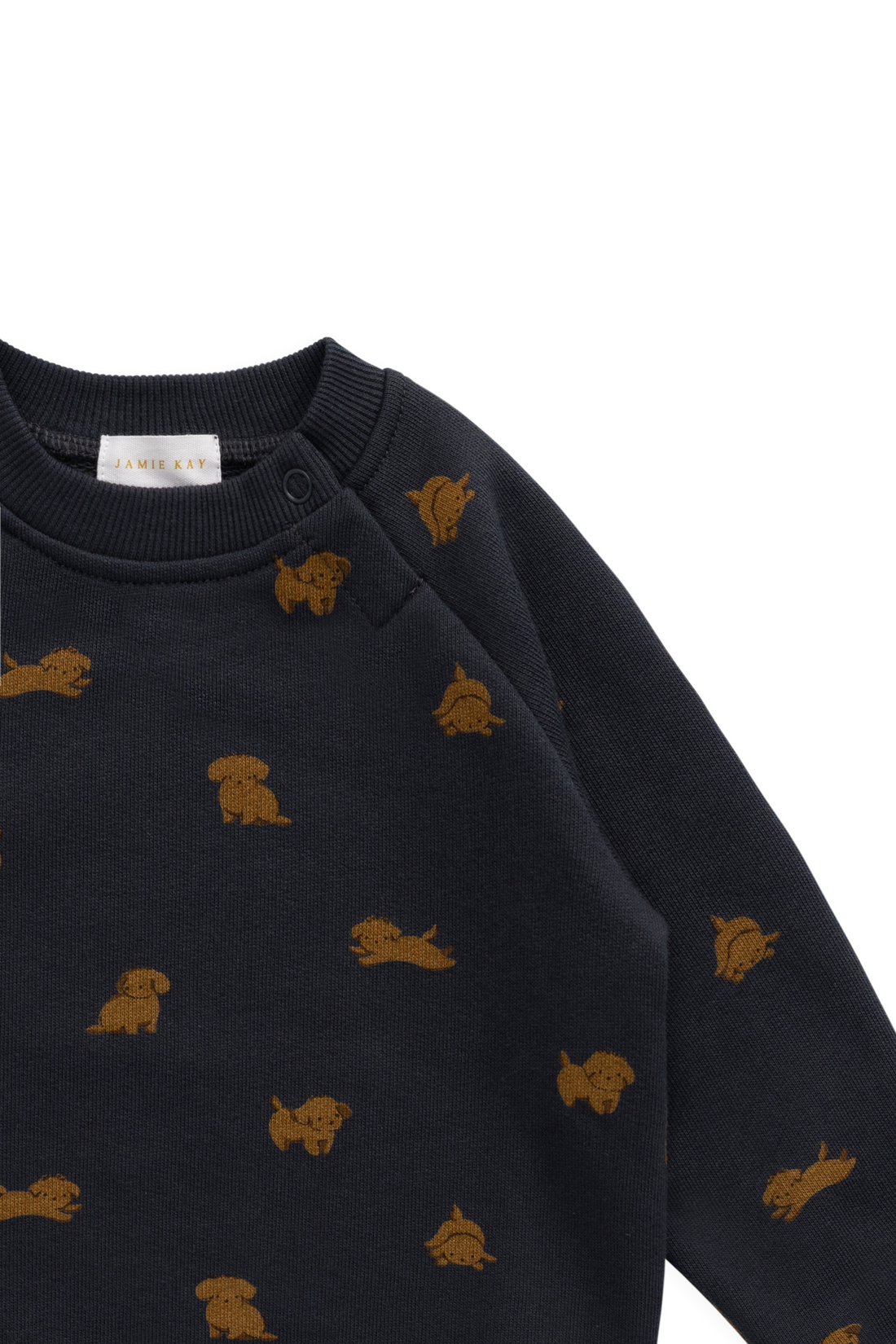 Close-up of a dark navy long-sleeve knit top with small mustard-gold dog motifs repeated across the fabric, shown on a plain white background.