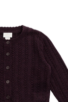 Dark purple knitted cardigan with buttons on a white background