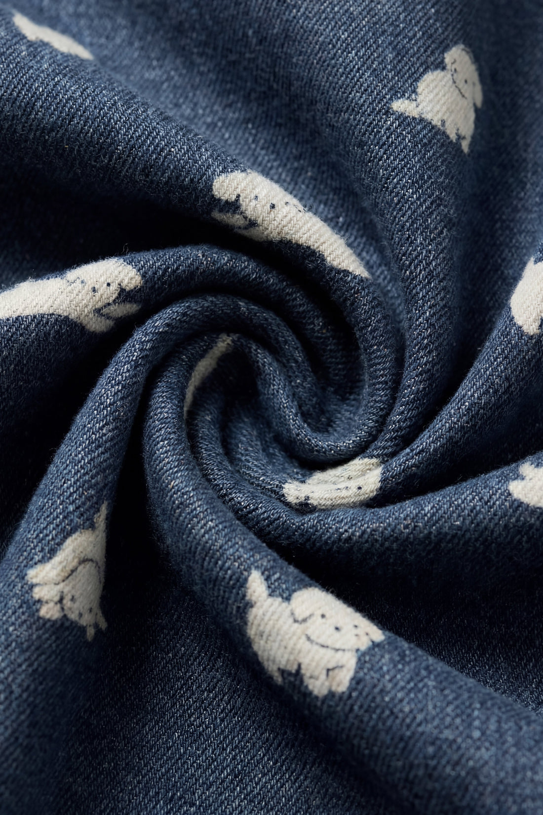 Close-up of blue fabric with white dog patterns