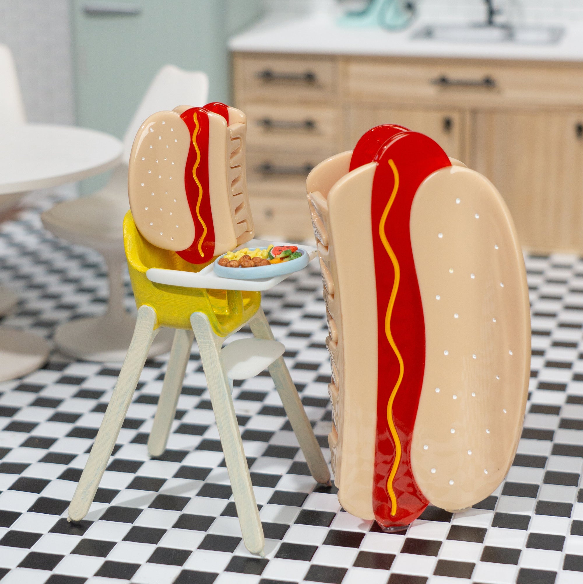 Two hot dog-shaped chairs with buns and sausages on a checkered floor in a kitchen setting.
