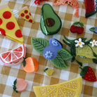 Colorful plastic food toys on a checkered tablecloth