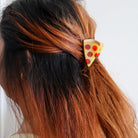 Person with pizza-shaped hair clip in their hair
