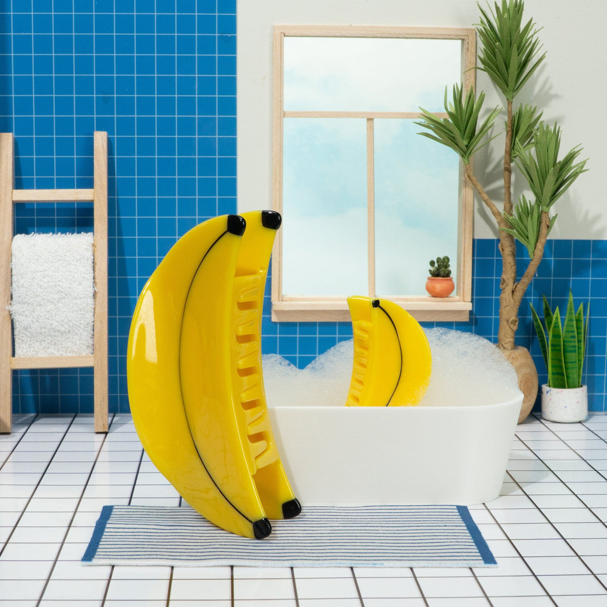 Yellow inflatable ring with banana design on a bathtub in a bathroom with blue tiles and plants.