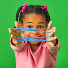 Child holding blue slime in front of a green background