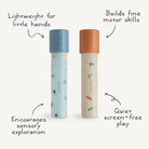Two Mushie paper kaleidoscopes standing vertically against a white background, featuring the Space and Dinosaurs pattern, surrounded by handwritten text highlights reading "Lightweight for little hands", "Builds fine motor skills", "Encourages sensory exploration", and "Quiet screen-free play".