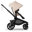 Beige and black stroller on a white background