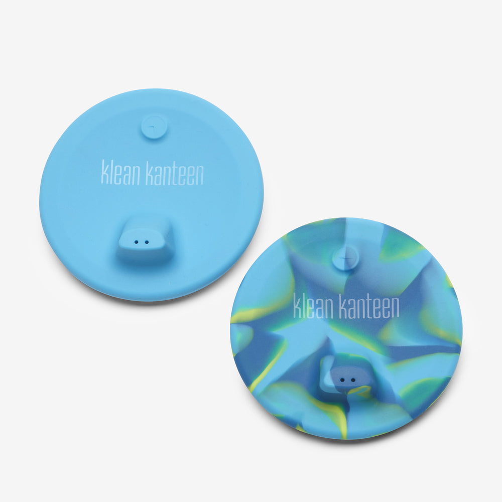 Two blue silicone lids with 'klean kanteen' branding on a light gray background