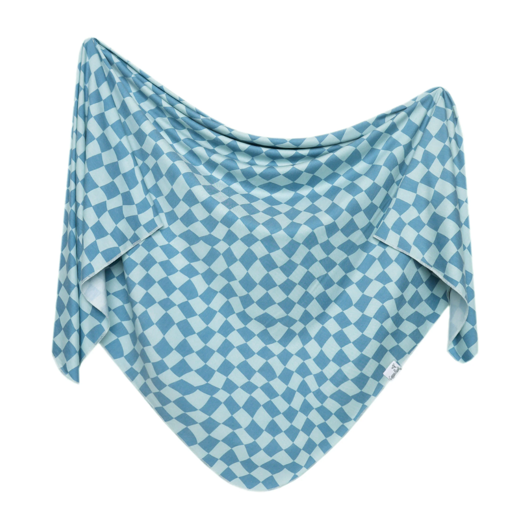 Blue and white checkered fabric draped over a white background