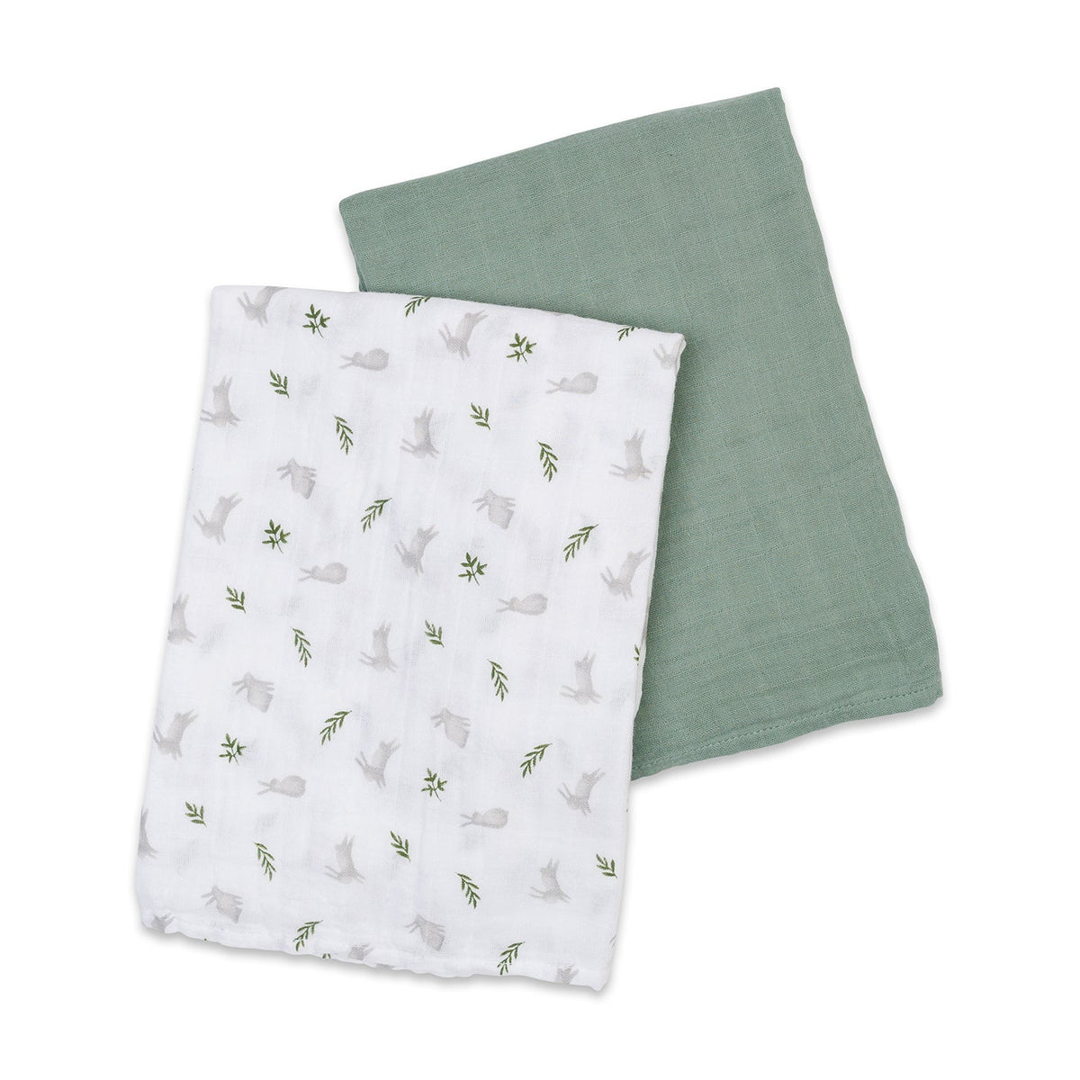 Two fabric swaddles, one with a pattern of animals and leaves on white, the other solid green, on a white background.
