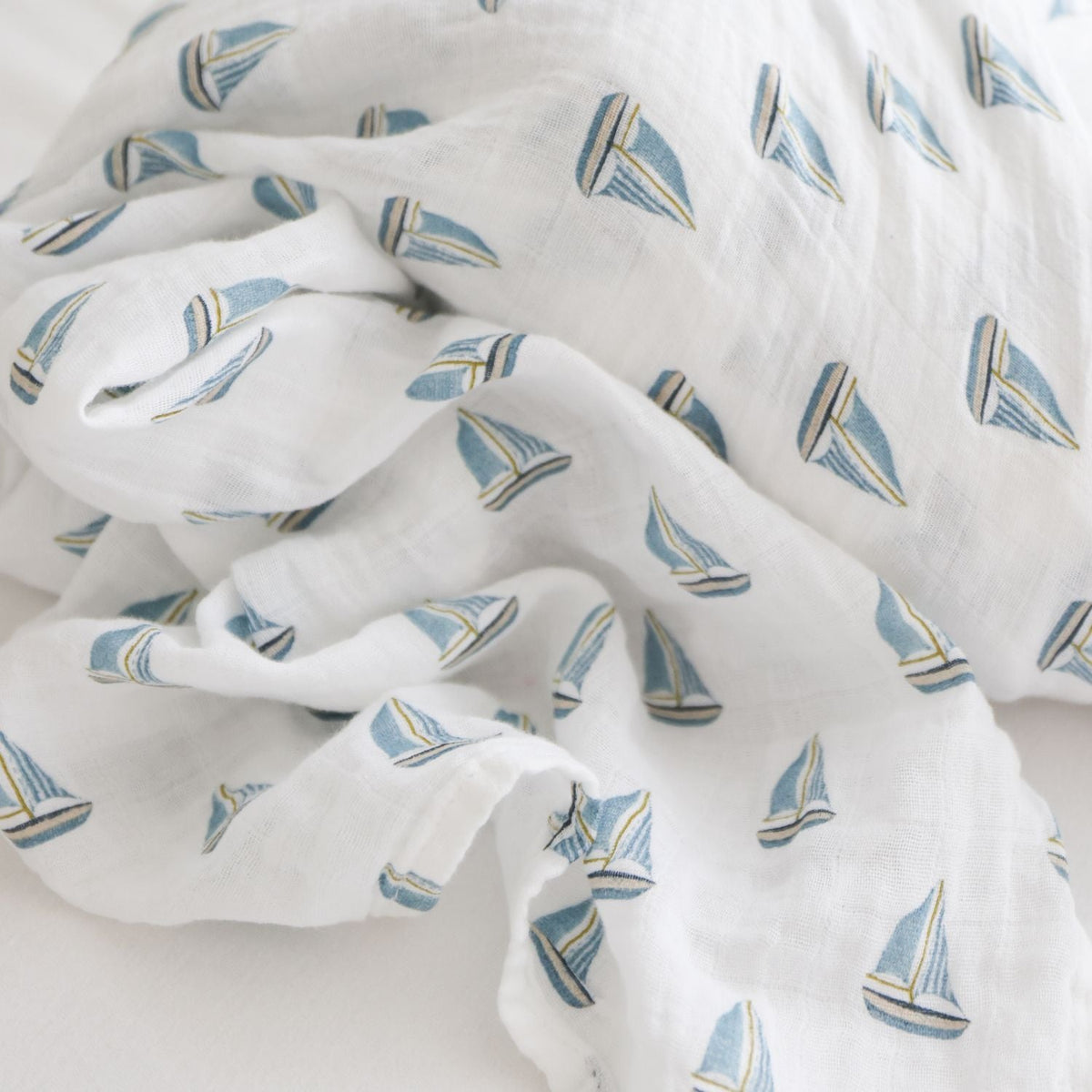 White fabric with blue sailboat pattern