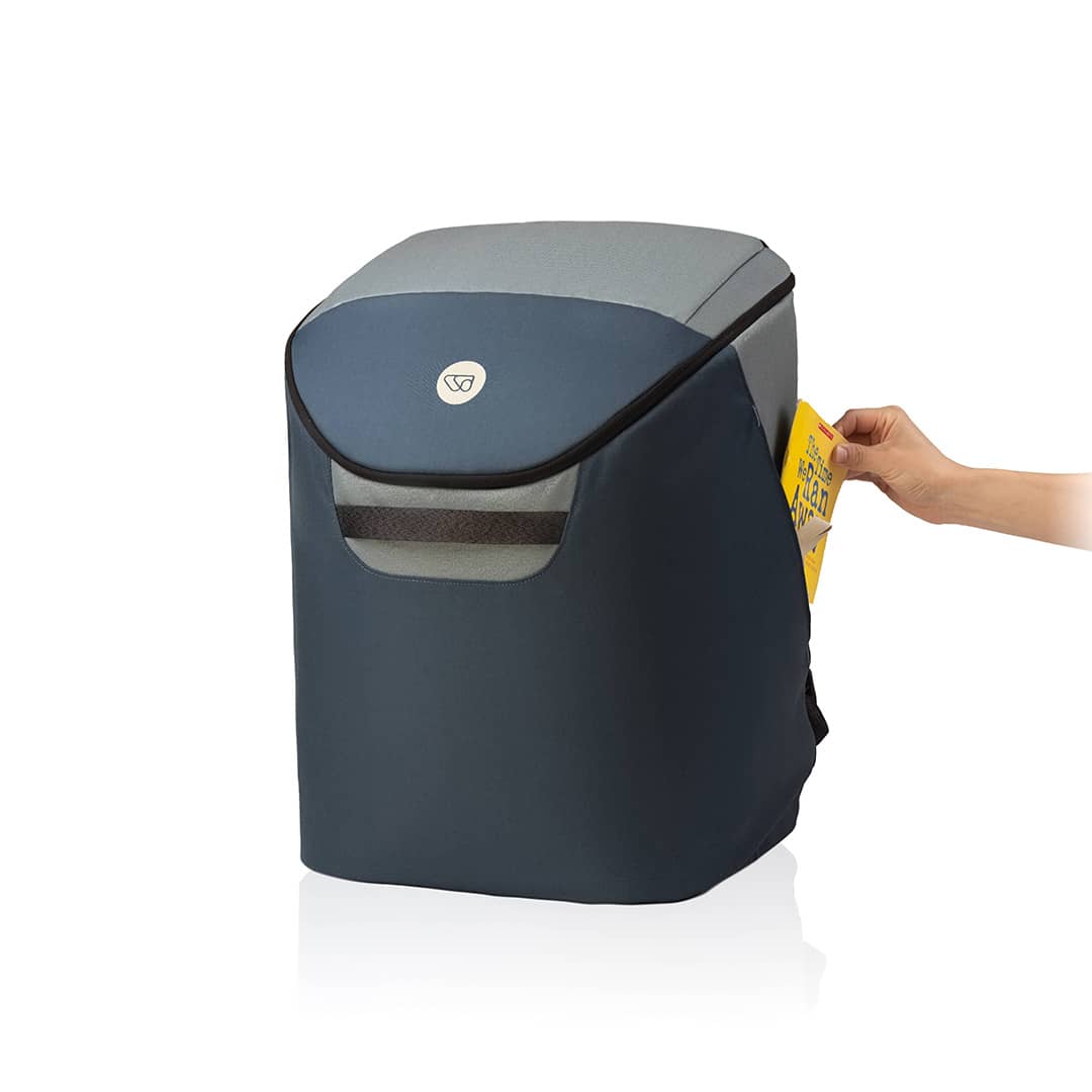Blue trash bin with a hand placing a yellow bag inside on a white background