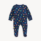 A baby footed one-piece sleeper in navy blue with a colorful sports-themed print of football helmets, footballs, hoops, and words like 'catch', 'run', and 'score', shown flat on a light gray background.