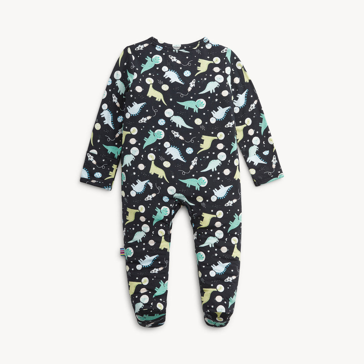 A baby footed one-piece jumpsuit in black with an all-over dinosaur and space-themed print, shown flat against a light off-white background.