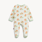 A baby footed one-piece sleeper with long sleeves and an all-over print of orange dogs wearing green sweaters on an off-white background, finished with light green ribbed trim.