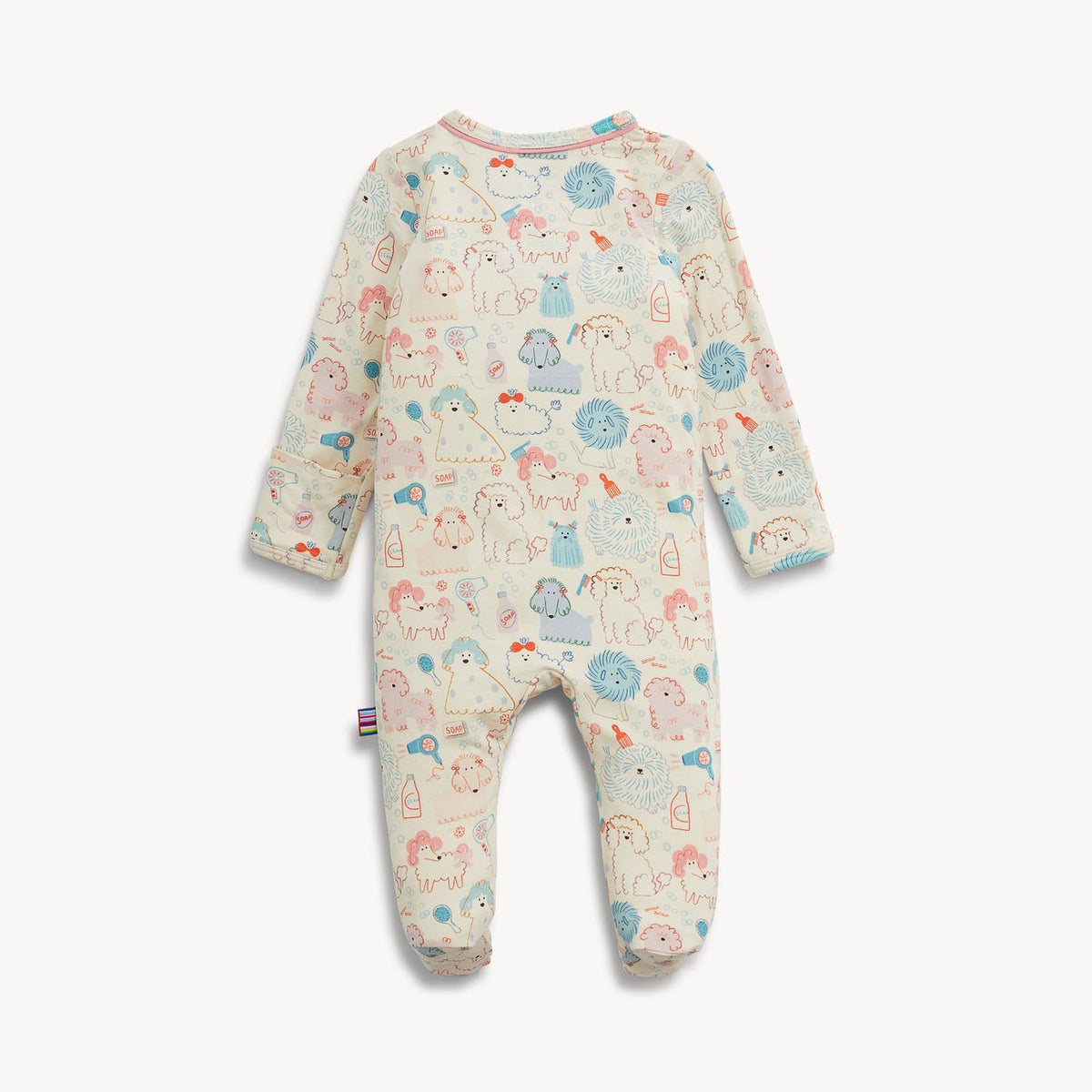 A baby footed one-piece jumpsuit in cream with a colorful cartoon unicorn and animal pattern, shown flat on a light gray background.