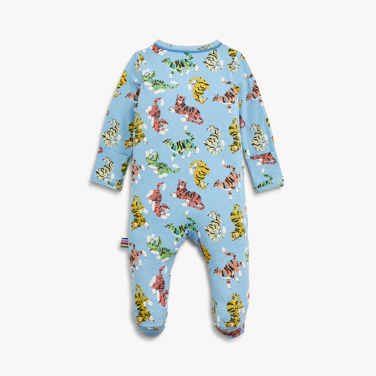 A baby footed one-piece sleeper in light blue with an all-over print of cartoon tigers in orange, yellow, green, and pink, shown on a light gray background.
