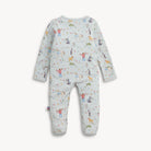 A baby long-sleeve footed one-piece romper in a light grayish-blue color, featuring an all-over playful print of penguins, horses, and people with colorful flags and trees.