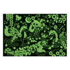 Glow-in-the-dark view of the assembled Unicorn Dreams Puzzle showing the illustrated unicorns, flowers, and stars glowing in bright green against a dark background.