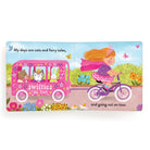 Children's book page with a girl on a bike and a pink vehicle with animal characters, set against a colorful outdoor background.