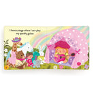 Children's book page with a girl playing guitar, surrounded by animals and a rainbow.