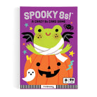 Halloween-themed card game box with a frog in a pumpkin costume on a purple background
