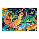 A product photo of the Dinosaur Park 100 Piece Glow in the Dark Puzzle by Mudpuppy completed puzzle against a white background, featuring a colorful prehistoric scene with various illustrated dinosaurs in a park.